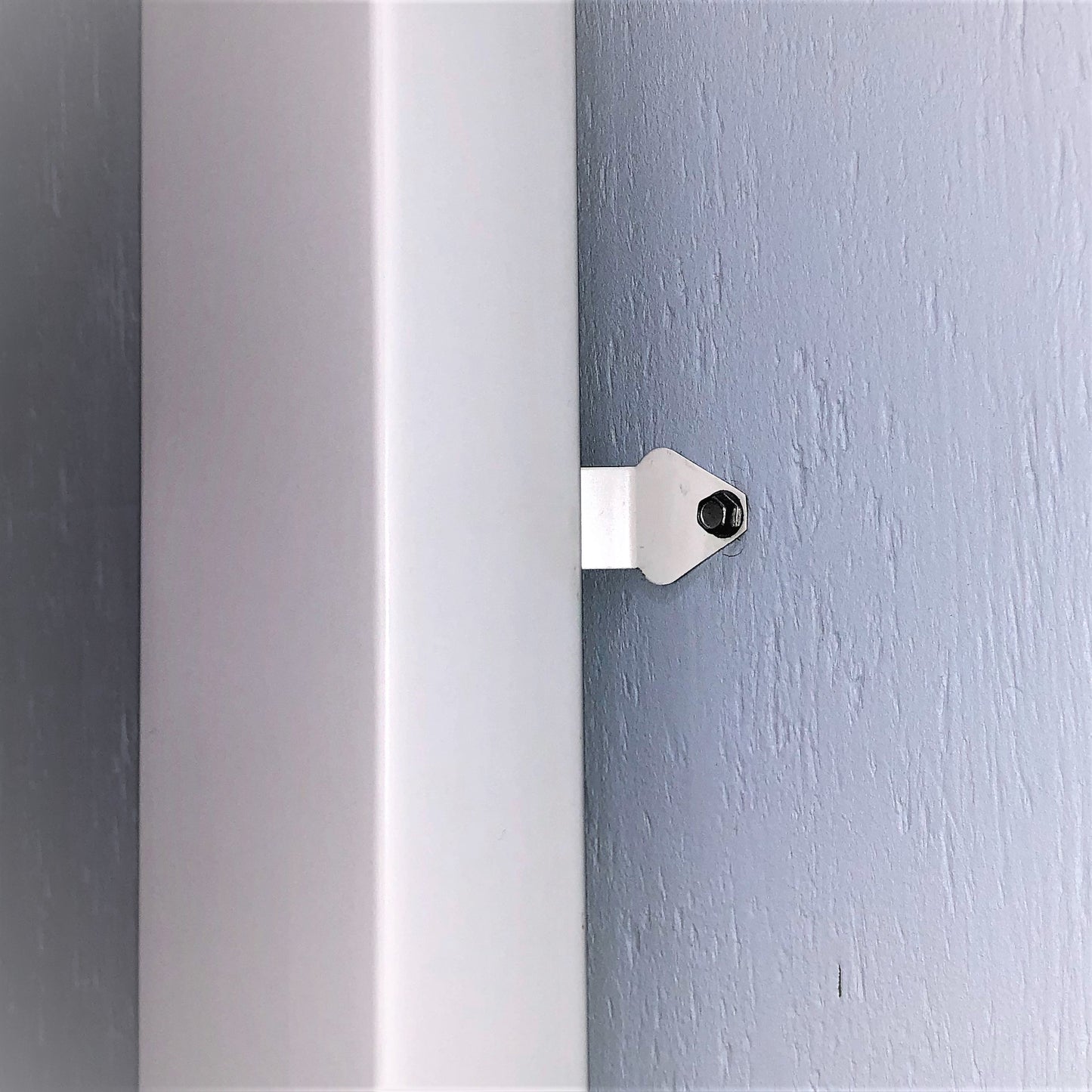 Installed downspout mounting cleat bracket securing a gutter system.