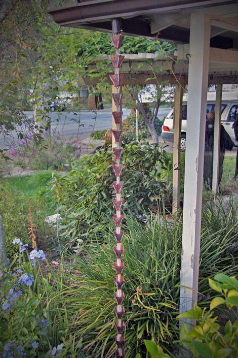 Full view of copper petal top rain chain installed on a house.