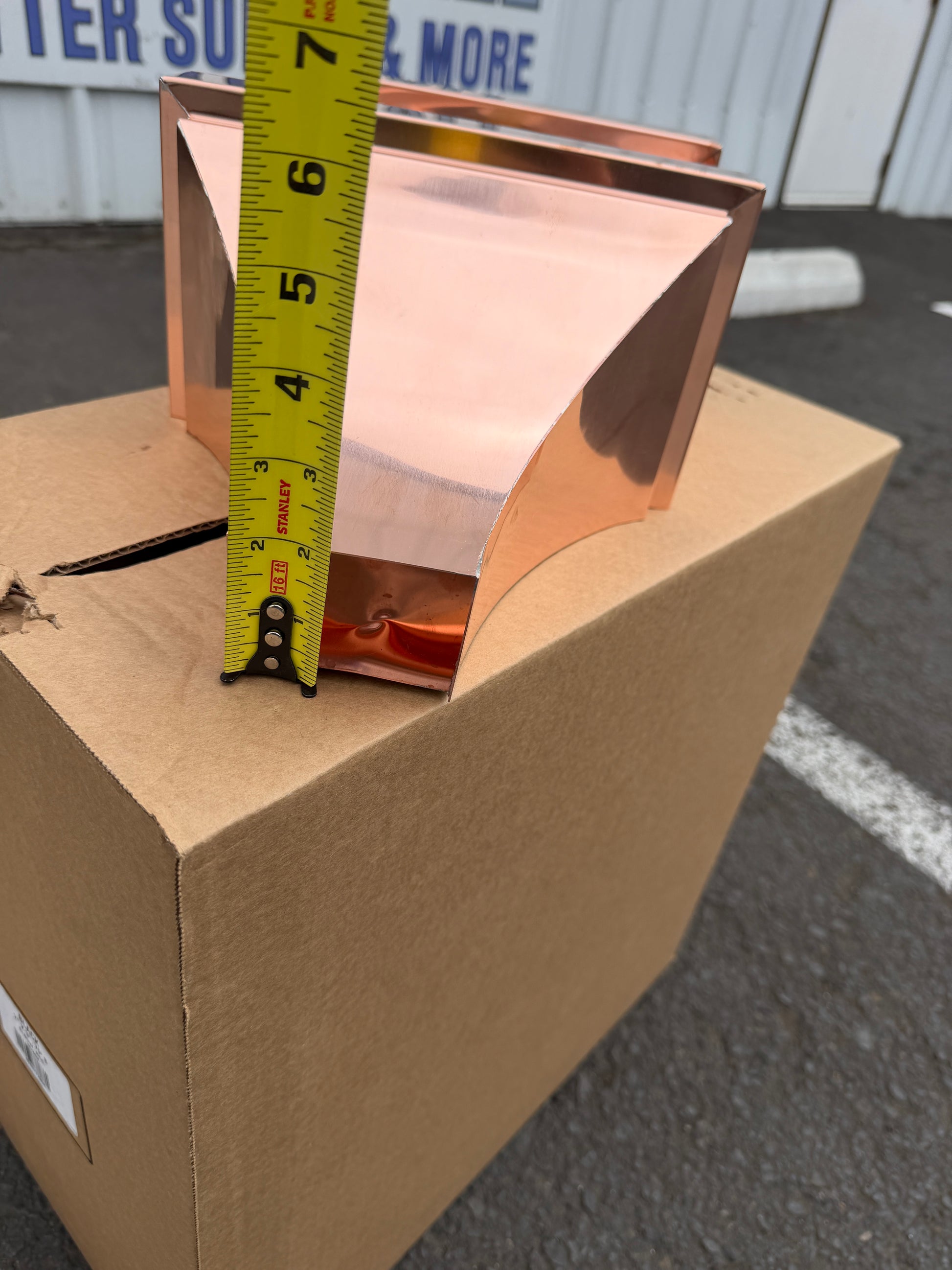 Small copper conductor head single crown style 10x6x13 inch leader head rain collector box featuring single crown top smooth curved face decorative bands and 2x3 square downspout outlet in bright mill finish 16 oz copper by GutterAll Damascus Oregon