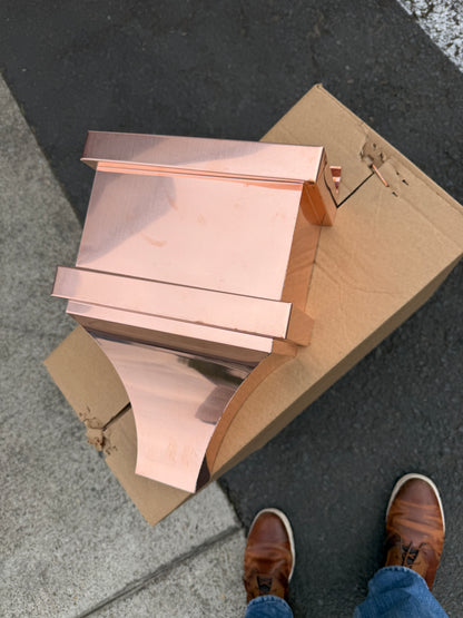 Small copper conductor head single crown style 10x6x13 inch leader head rain collector box featuring single crown top smooth curved face decorative bands and 2x3 square downspout outlet in bright mill finish 16 oz copper by GutterAll Damascus Oregon