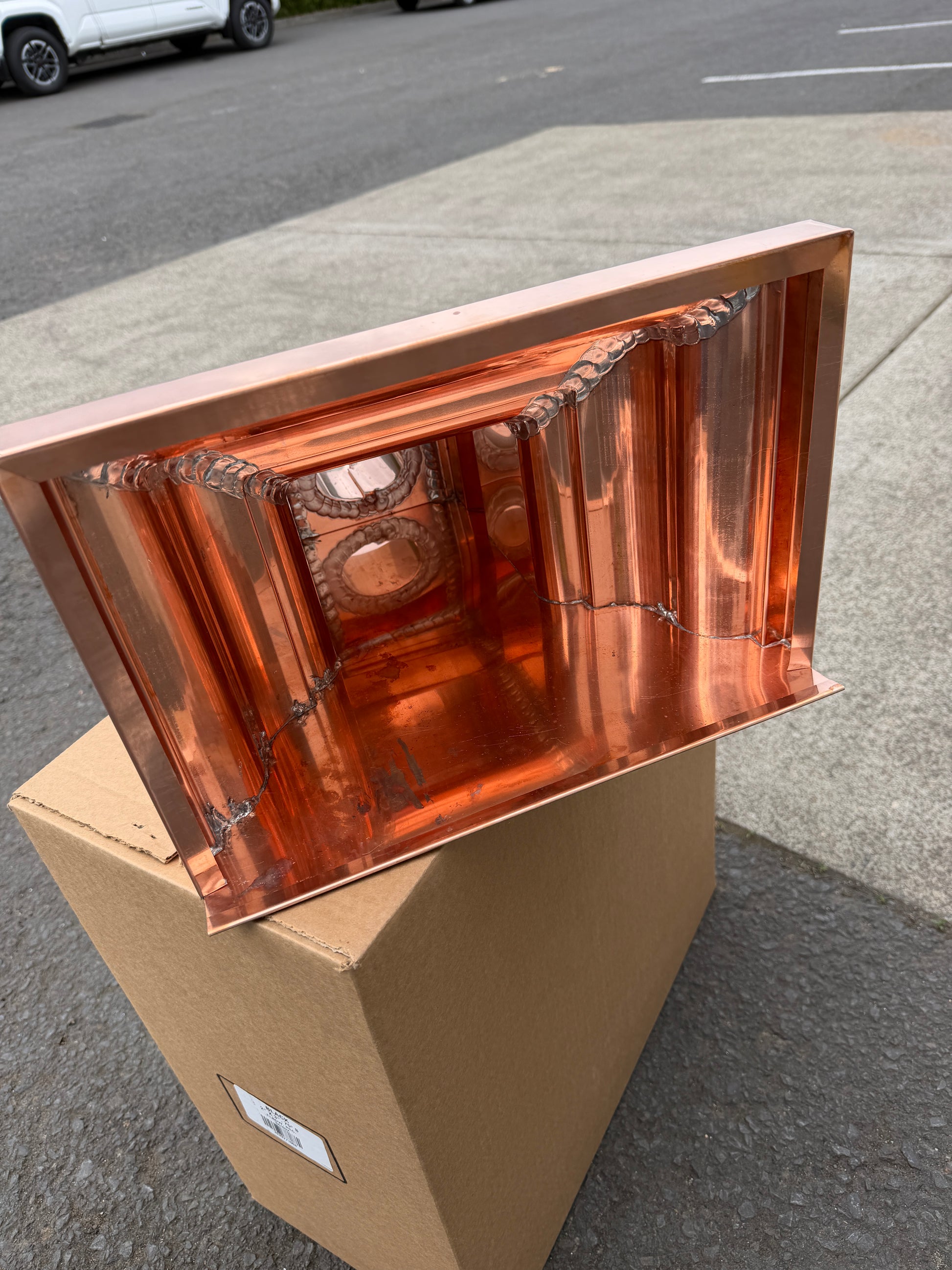 Copper conductor head crown style 14x10x14 inch leader head rain collector box featuring decorative crown profile stacked molding deep curved bowl and 2x3 oval downspout outlet in bright mill finish 16 oz copper by GutterAll Damascus Oregon