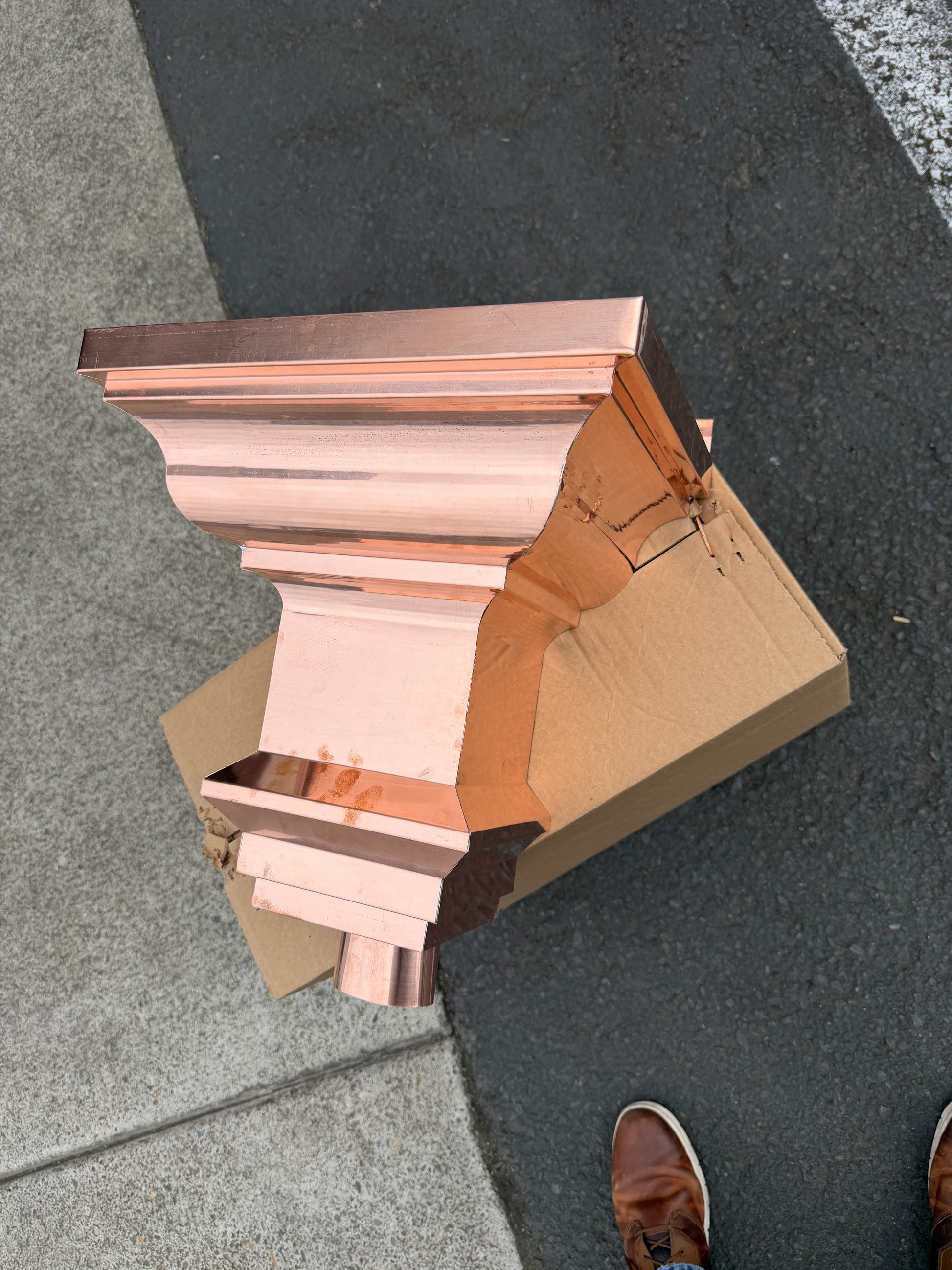 Copper conductor head crown style 14x10x14 inch leader head rain collector box featuring decorative crown profile stacked molding deep curved bowl and 2x3 oval downspout outlet in bright mill finish 16 oz copper by GutterAll Damascus Oregon