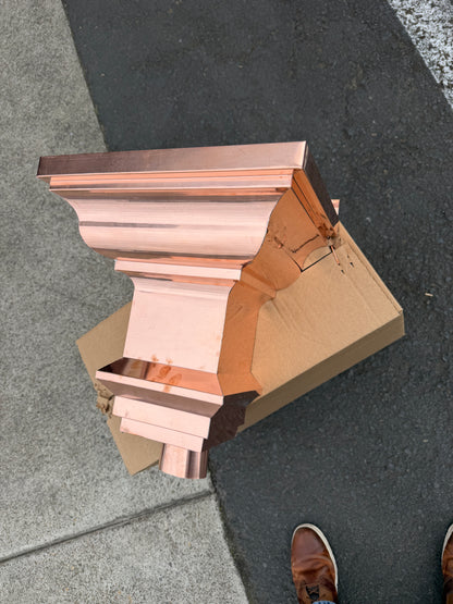 Copper conductor head crown style 14x10x14 inch leader head rain collector box featuring decorative crown profile stacked molding deep curved bowl and 2x3 oval downspout outlet in bright mill finish 16 oz copper by GutterAll Damascus Oregon