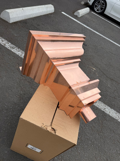 Copper conductor head crown style 14x10x14 inch leader head rain collector box featuring decorative crown profile stacked molding deep curved bowl and 2x3 oval downspout outlet in bright mill finish 16 oz copper by GutterAll Damascus Oregon