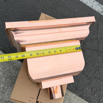 Copper conductor head leader head rain collector box 14x10x11 inch crown molding design smooth curved front 2x3 oval outlet polished copper finish architectural gutter accessory custom homes upscale remodels GutterAll Damascus Oregon
