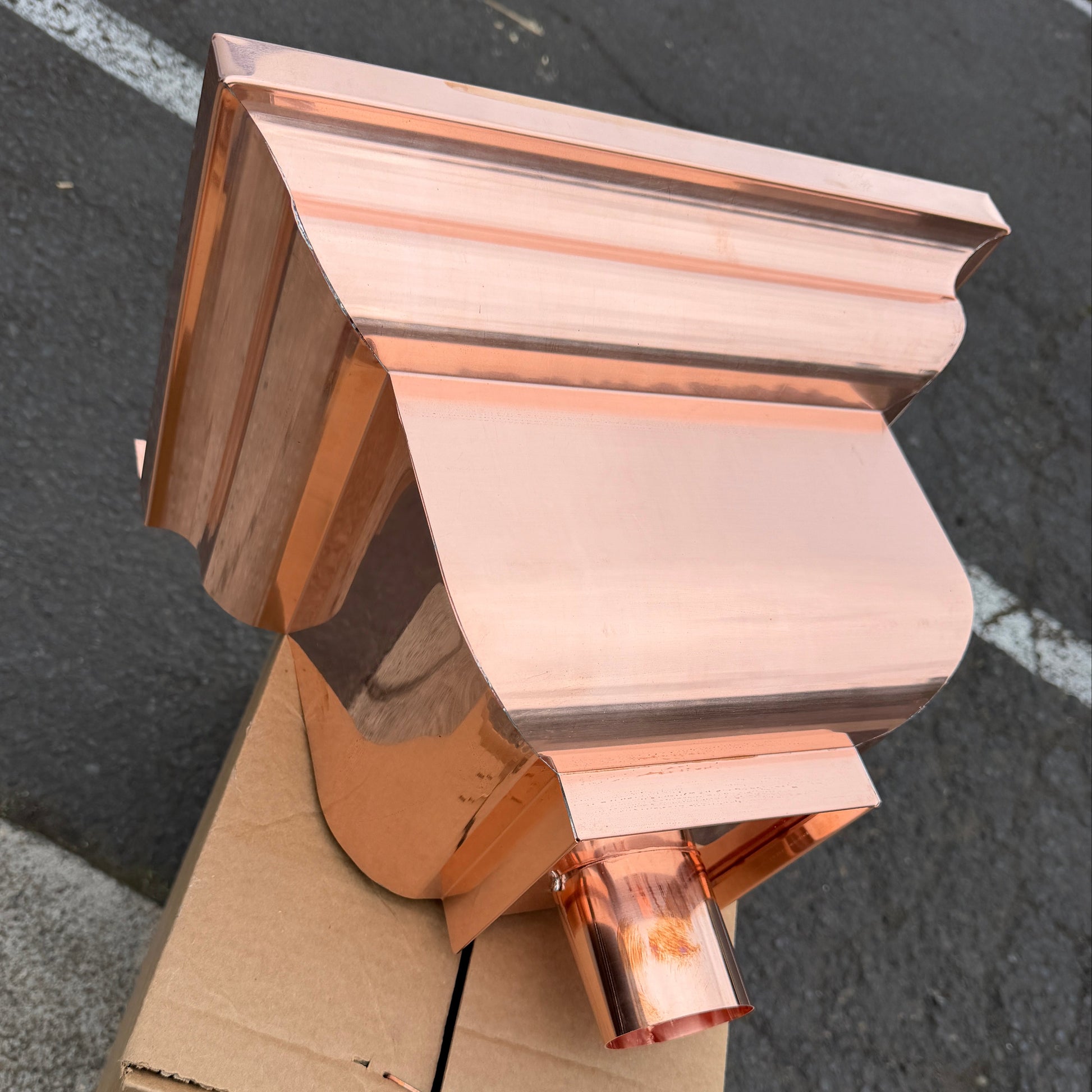 Copper conductor head leader head rain collector box 14x10x11 inch crown molding design smooth curved front 2x3 oval outlet polished copper finish architectural gutter accessory custom homes upscale remodels GutterAll Damascus Oregon