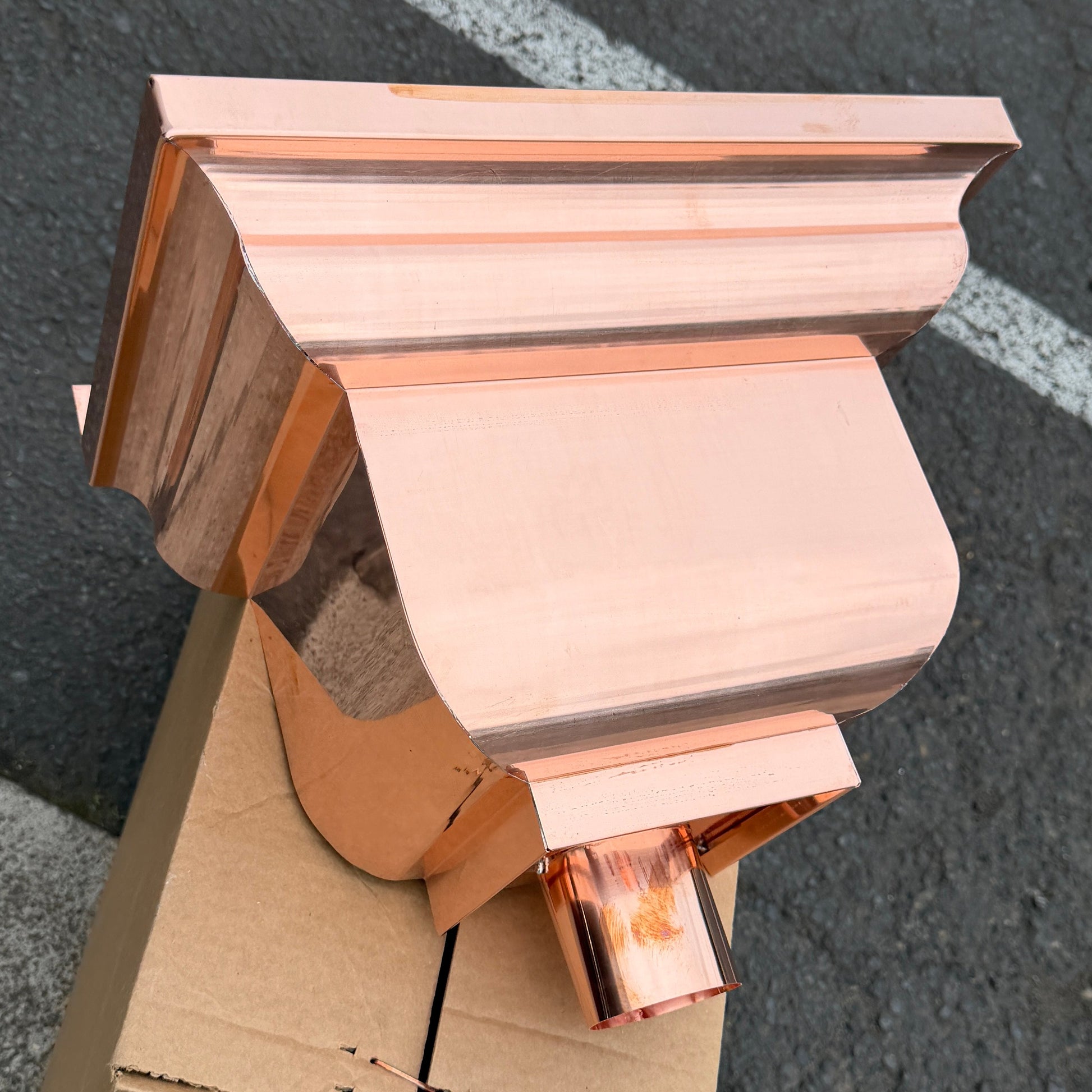 Copper conductor head leader head rain collector box 14x10x11 inch crown molding design smooth curved front 2x3 oval outlet polished copper finish architectural gutter accessory custom homes upscale remodels GutterAll Damascus Oregon
