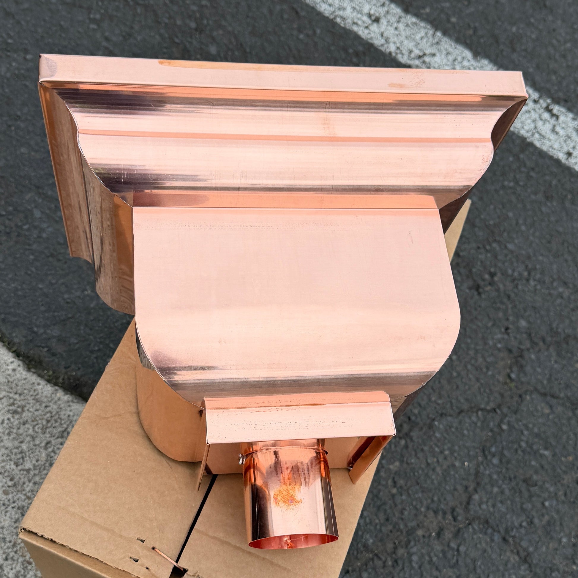 Copper conductor head leader head rain collector box 14x10x11 inch crown molding design smooth curved front 2x3 oval outlet polished copper finish architectural gutter accessory custom homes upscale remodels GutterAll Damascus Oregon