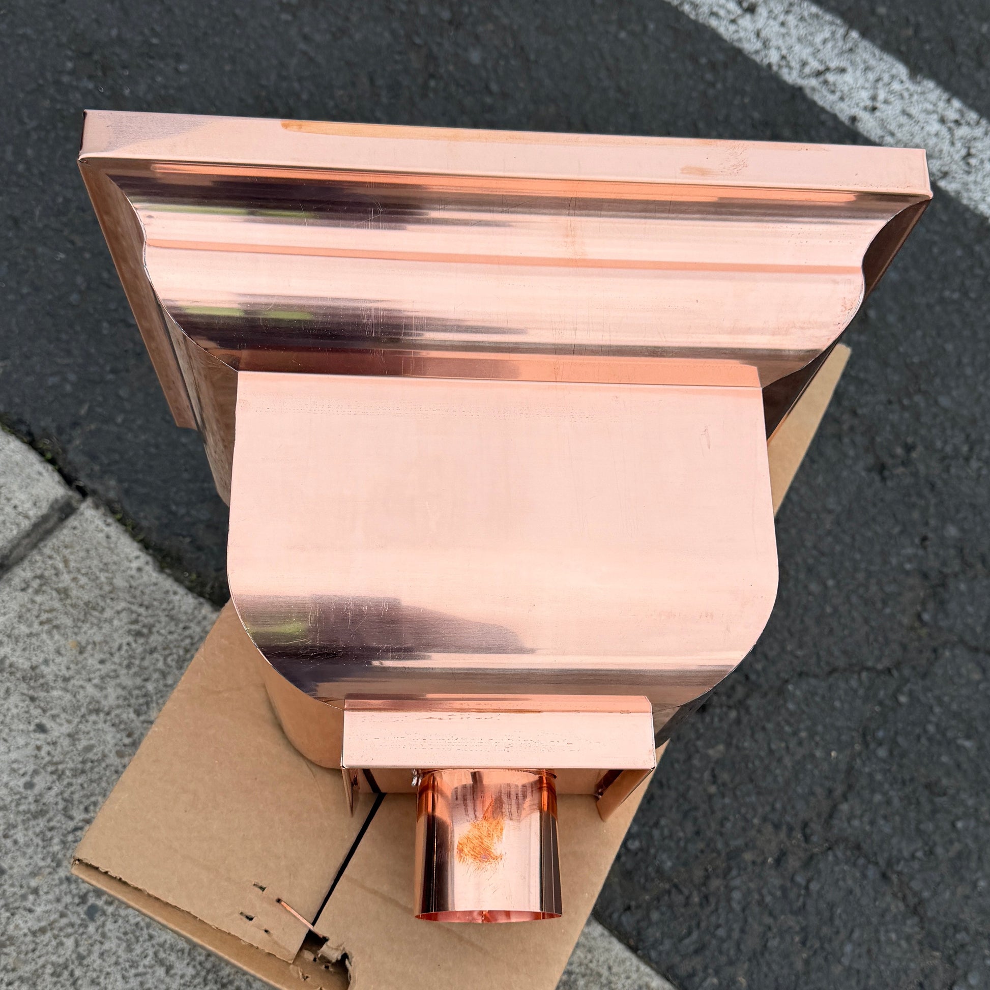Copper conductor head leader head rain collector box 14x10x11 inch crown molding design smooth curved front 2x3 oval outlet polished copper finish architectural gutter accessory custom homes upscale remodels GutterAll Damascus Oregon