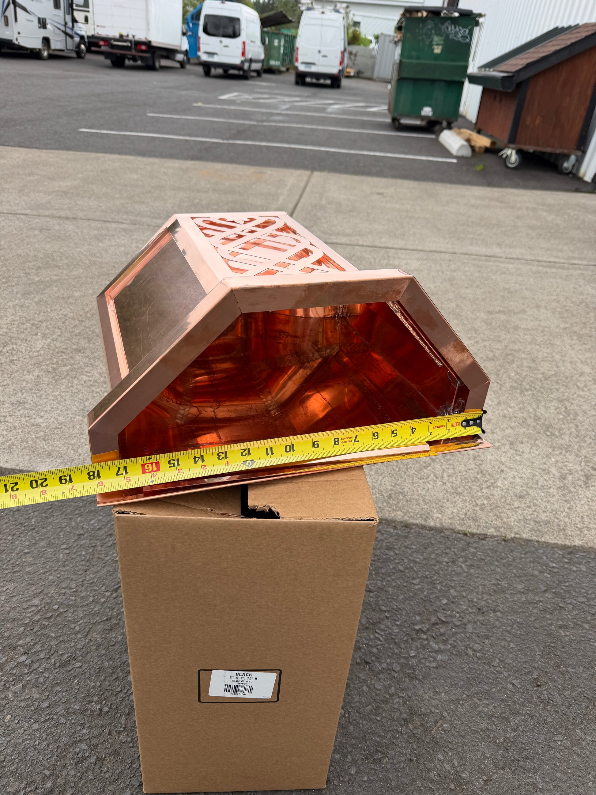 Ornamental copper conductor head with scroll cut decorative lattice front panel 18x8.5x20 inch leader head rain collector box featuring peaked gabled top faceted hexagonal body and 2x3 oval downspout outlet in bright mill finish 16 oz copper by GutterAll Damascus Oregon