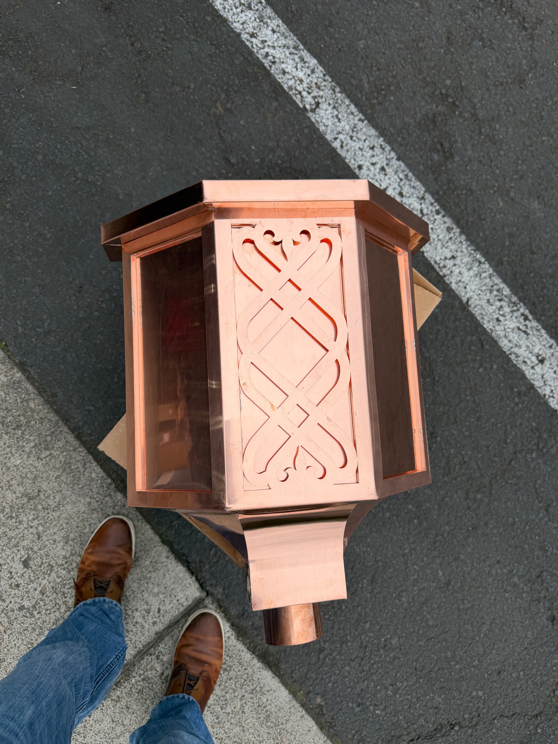Ornamental copper conductor head with scroll cut decorative lattice front panel 18x8.5x20 inch leader head rain collector box featuring peaked gabled top faceted hexagonal body and 2x3 oval downspout outlet in bright mill finish 16 oz copper by GutterAll Damascus Oregon