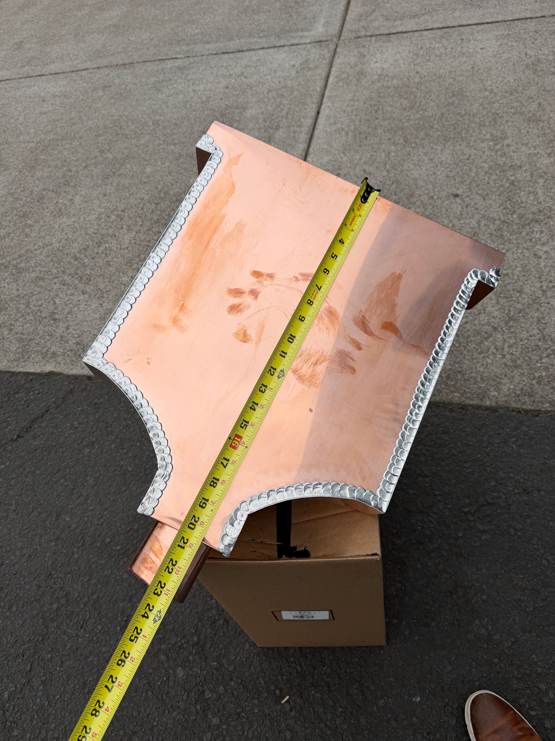 Ornamental copper conductor head with scroll cut decorative lattice front panel 18x8.5x20 inch leader head rain collector box featuring peaked gabled top faceted hexagonal body and 2x3 oval downspout outlet in bright mill finish 16 oz copper by GutterAll Damascus Oregon