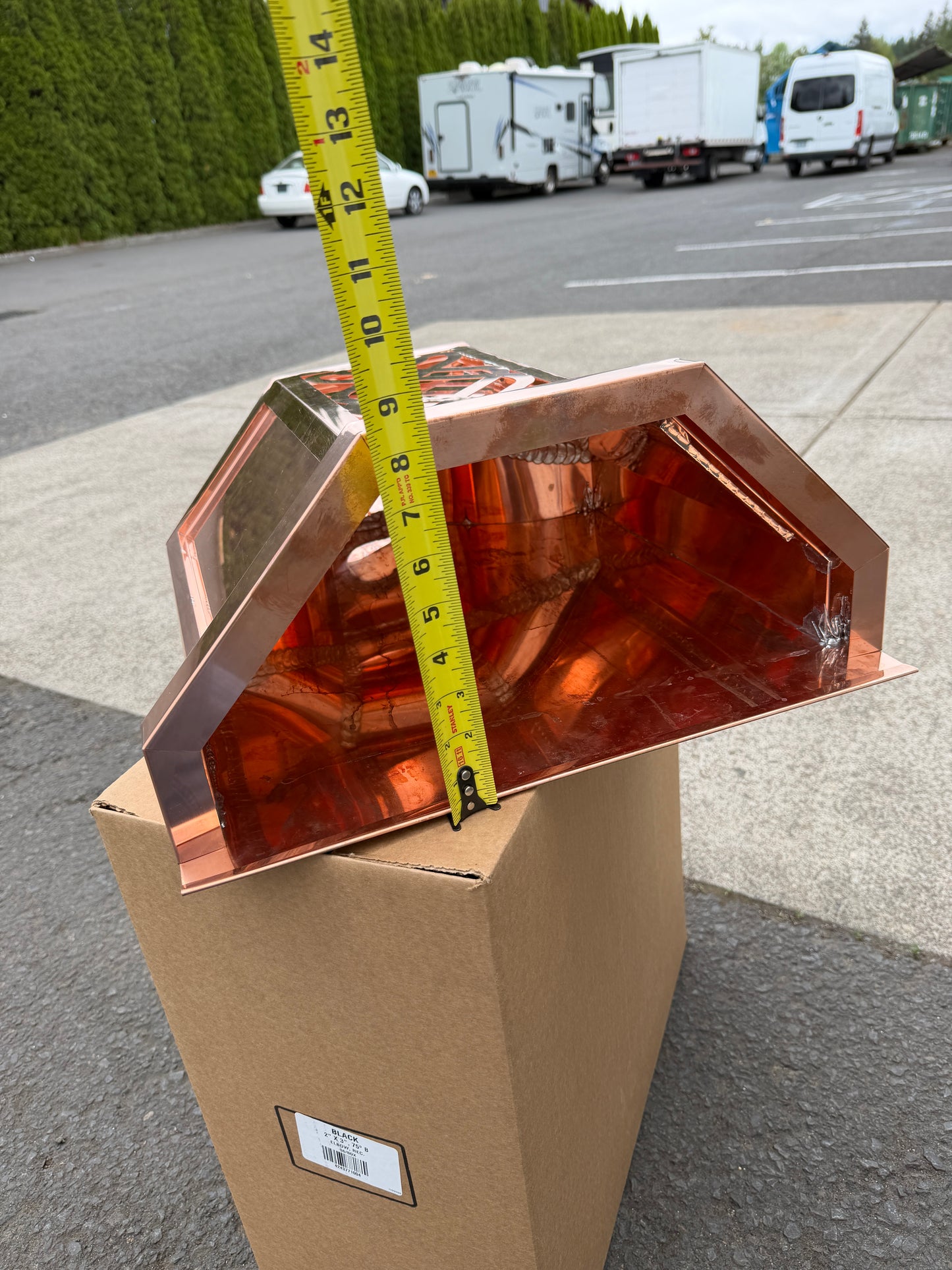 Ornamental copper conductor head with scroll cut decorative lattice front panel 18x8.5x20 inch leader head rain collector box featuring peaked gabled top faceted hexagonal body and 2x3 oval downspout outlet in bright mill finish 16 oz copper by GutterAll Damascus Oregon