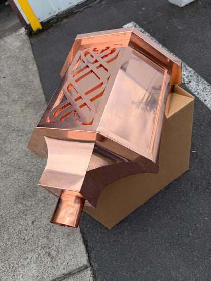 Ornamental copper conductor head with scroll cut decorative lattice front panel 18x8.5x20 inch leader head rain collector box featuring peaked gabled top faceted hexagonal body and 2x3 oval downspout outlet in bright mill finish 16 oz copper by GutterAll Damascus Oregon