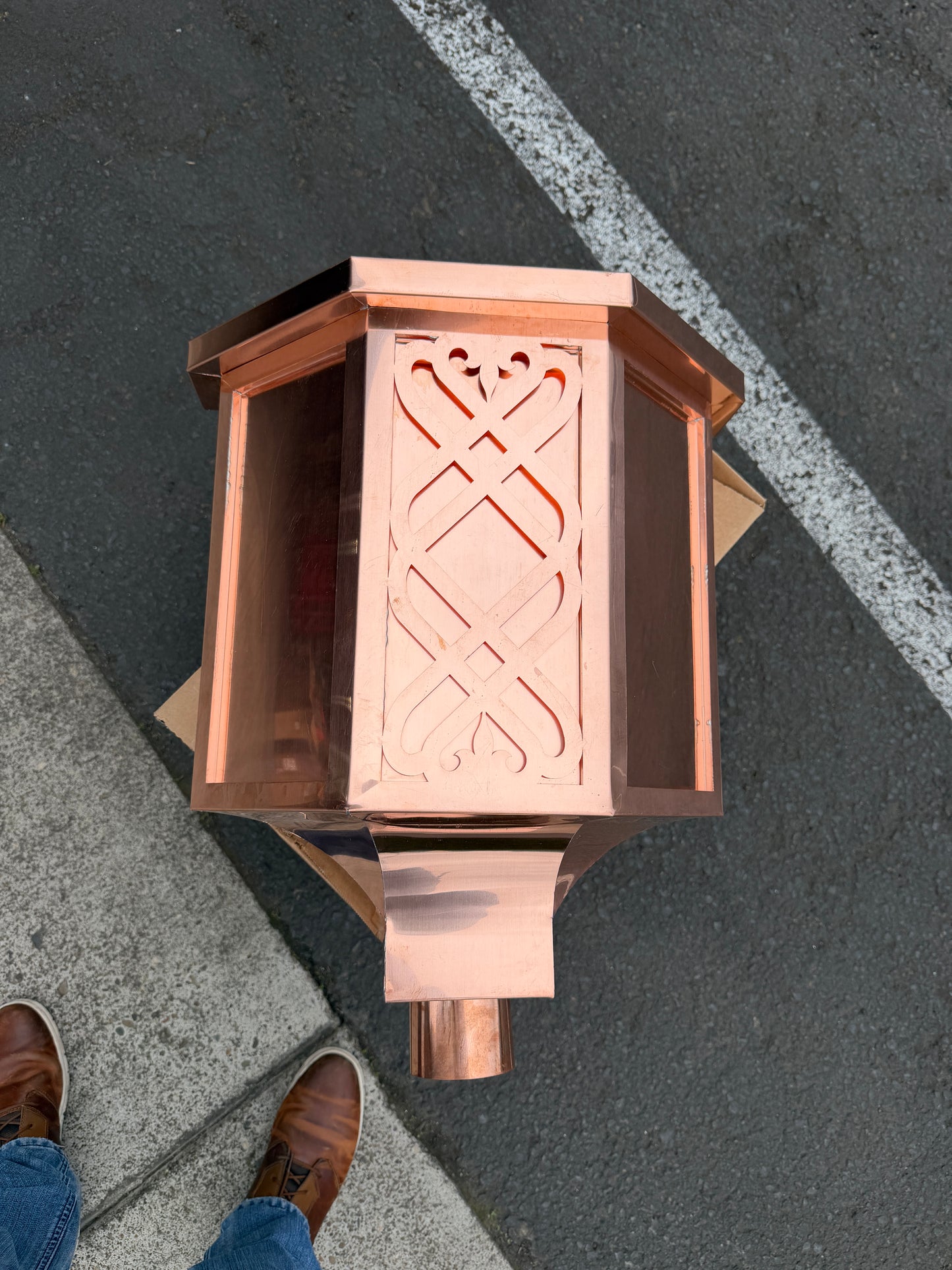 Ornamental copper conductor head with scroll cut decorative lattice front panel 18x8.5x20 inch leader head rain collector box featuring peaked gabled top faceted hexagonal body and 2x3 oval downspout outlet in bright mill finish 16 oz copper by GutterAll Damascus Oregon