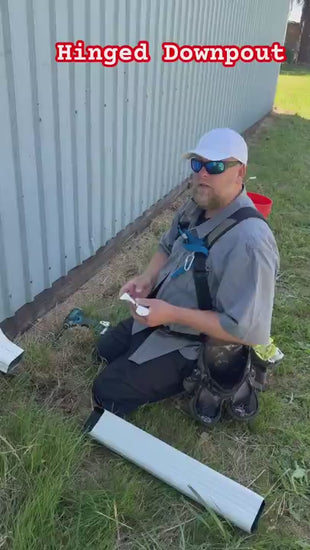 Expert presenter in Portland Oregon demonstrating best downspout extension kit 2025 
comparing flip-up aluminum hinge versus plastic alternatives for foundation protection 
and water drainage solution
