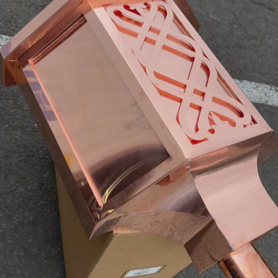 Ornamental copper conductor head with scroll cut decorative lattice front panel 18x8.5x20 inch leader head rain collector box featuring peaked gabled top faceted hexagonal body and 2x3 oval downspout outlet in bright mill finish 16 oz copper by GutterAll Damascus Oregon