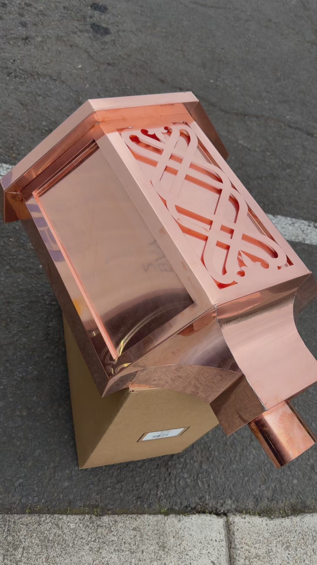 Ornamental copper conductor head with scroll cut decorative lattice front panel 18x8.5x20 inch leader head rain collector box featuring peaked gabled top faceted hexagonal body and 2x3 oval downspout outlet in bright mill finish 16 oz copper by GutterAll Damascus Oregon