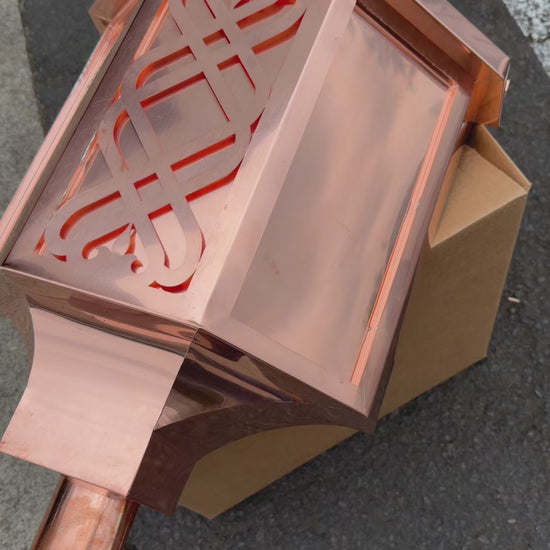 Ornamental copper conductor head with scroll cut decorative lattice front panel 18x8.5x20 inch leader head rain collector box featuring peaked gabled top faceted hexagonal body and 2x3 oval downspout outlet in bright mill finish 16 oz copper by GutterAll Damascus Oregon