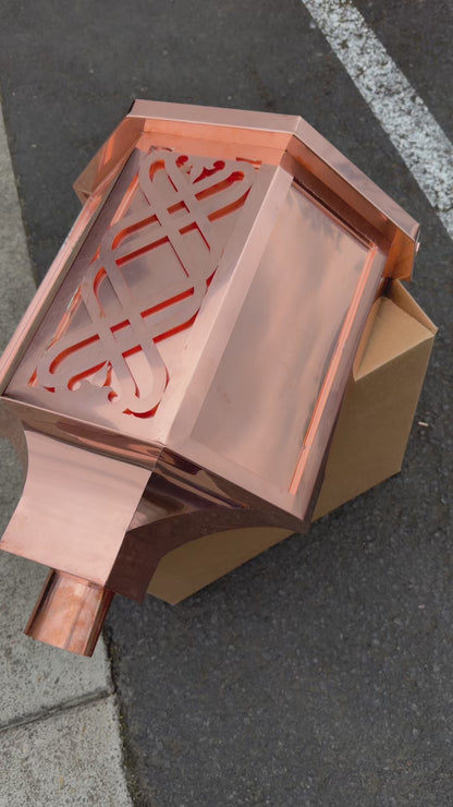 Ornamental copper conductor head with scroll cut decorative lattice front panel 18x8.5x20 inch leader head rain collector box featuring peaked gabled top faceted hexagonal body and 2x3 oval downspout outlet in bright mill finish 16 oz copper by GutterAll Damascus Oregon