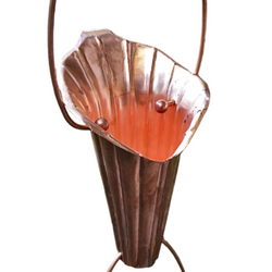 Handcrafted copper Lotus Flower Rain Chain showcasing intricate petal design and water flow in a garden setting