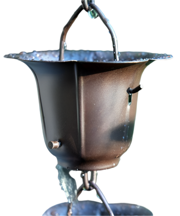 Close-up of a dark bronze buttercup rain chain cup with water flowing through.