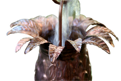 Handcrafted copper pineapple rain chain with detailed leaf crown and natural patina finish