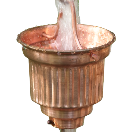 Close-up of a copper rain chain cup with water flowing through it. Fluted Cup Copper Rain Chain. Classic column design. 8ft section. 16 cups. 4-1/4" x 3". Vertical fluted ribbing. V-hook included. Contractor DIY. Damascus OR.