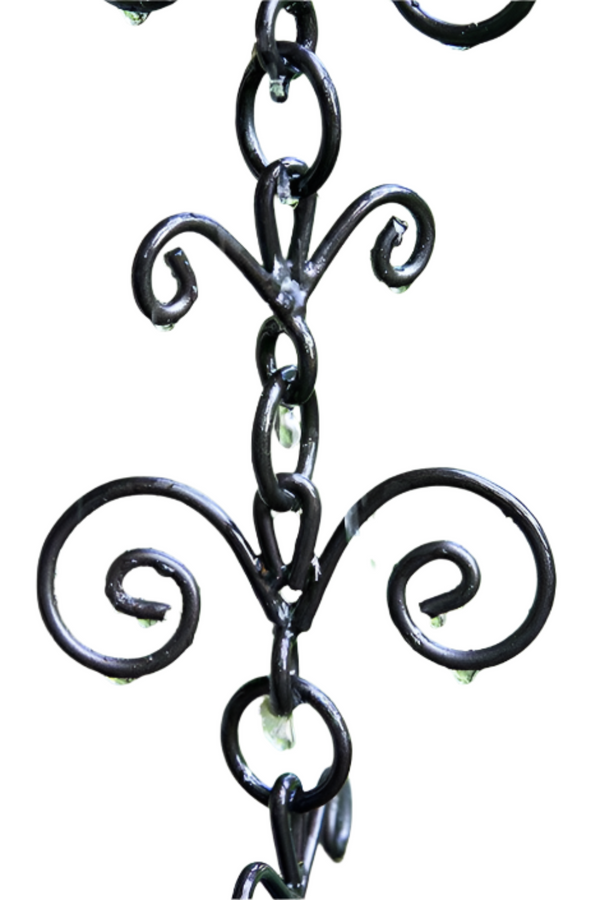 Close-up of decorative French flower rain chain with intricate black metal design.