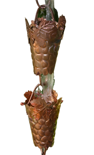 Two connected copper grapevine rain chain cups with water streaming through.