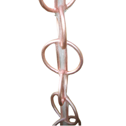 Copper rain chain with water flowing through its geometric hoops.