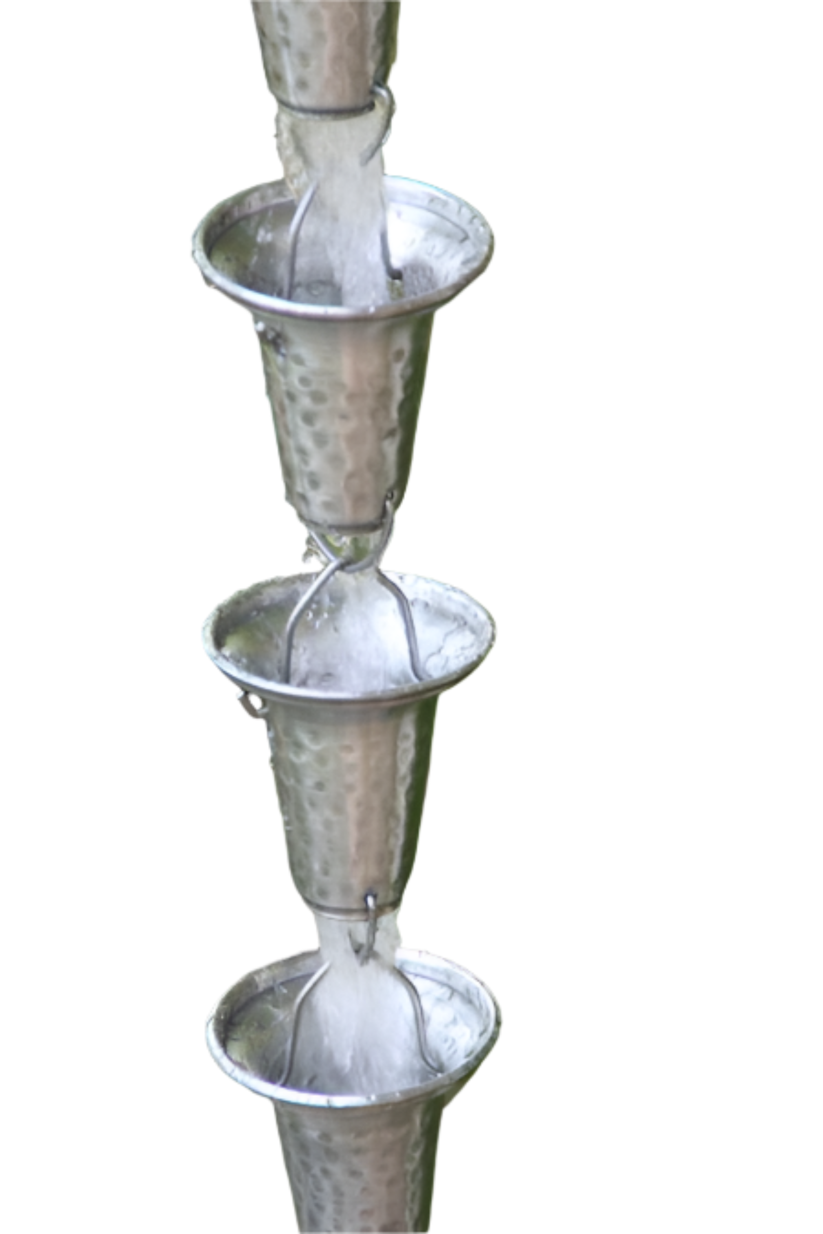 Water flowing through multiple cups of a spotted bell cup rain chain.
