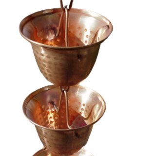 Close-up of copper spotted bell cup rain chain with hammered texture.