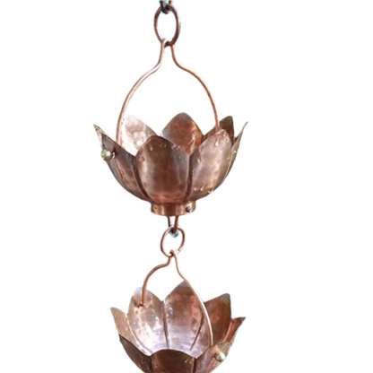 Copper hammered lotus flower rain chain with decorative design.