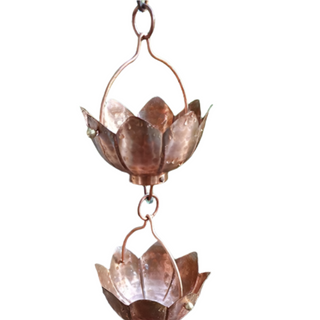 Copper hammered lotus flower rain chain with decorative design.