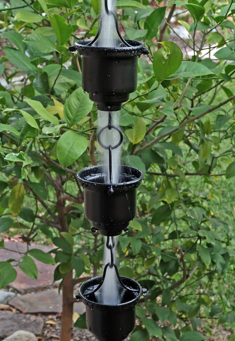 Black Tea Cup Rain Chain. Aluminum with black powder coat. 8ft section with 16 cups. 4-1/4" x 3" x 1" cups. Stainless hardware. V-hook included. Easy no-tool assembly. Contractor DIY. Damascus OR.