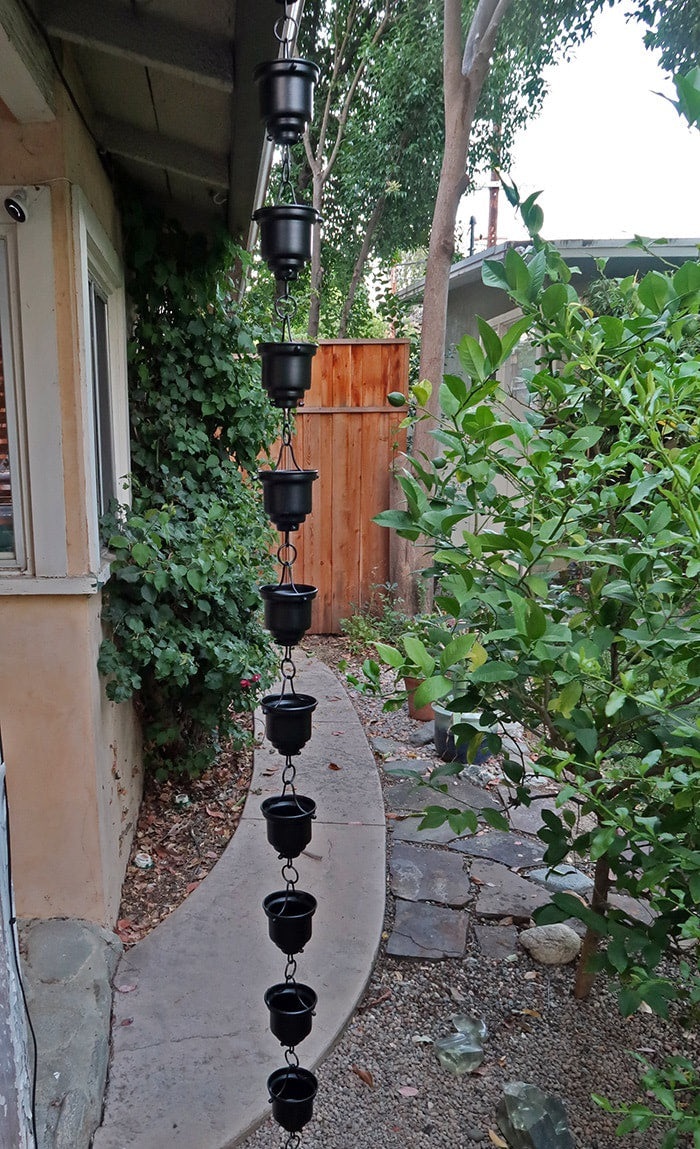 Black Tea Cup Rain Chain. Aluminum with black powder coat. 8ft section with 16 cups. 4-1/4" x 3" x 1" cups. Stainless hardware. V-hook included. Easy no-tool assembly. Contractor DIY. Damascus OR.