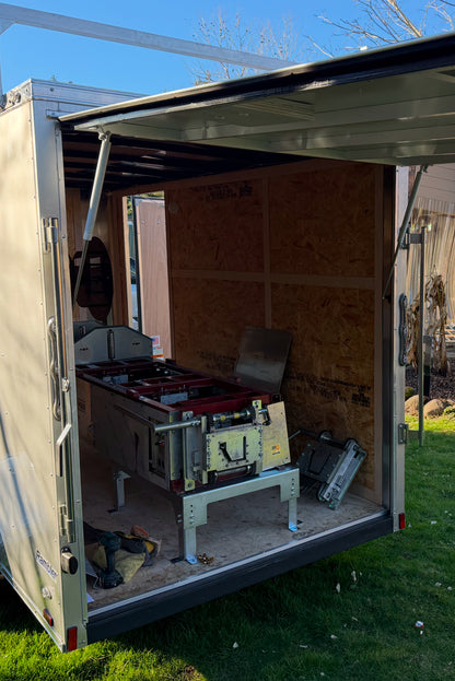 Enclosed gutter trailer with rear door converted to lift upward over seamless gutter machine using heavy-duty gas struts GutterAll Damascus Oregon