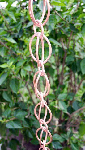 Egg-Shaped Loop Rain Chain in Copper Bronze finish showing unique figure-8 design and water flow pattern