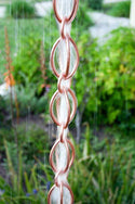 Egg-Shaped Loop Rain Chain in Copper Bronze finish showing unique figure-8 design and water flow pattern