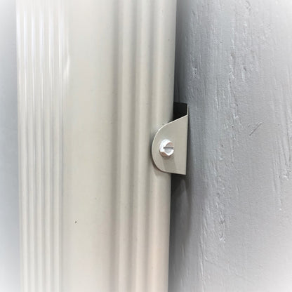 Close-up of aluminum downspout clip mounted with a screw on a gutter pipe.