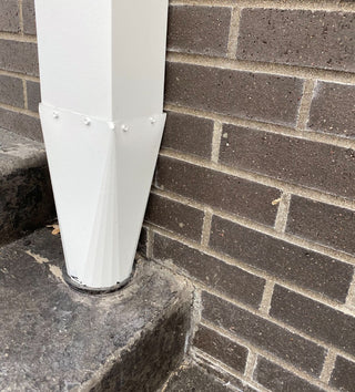 GutterAll.com Installed white aluminum downspout reducer on brick wall