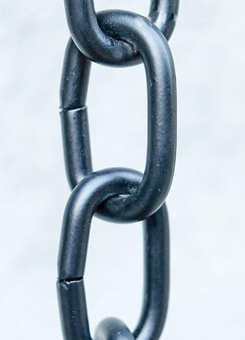 Detailed view of professional black aluminum rain chain links.