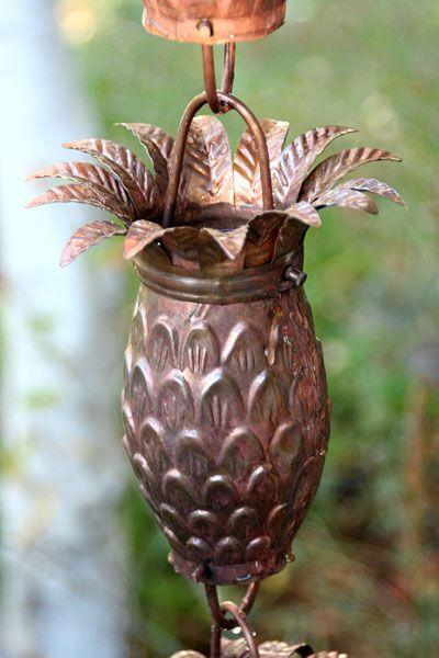 Handcrafted copper pineapple rain chain with detailed leaf crown and natural patina finish