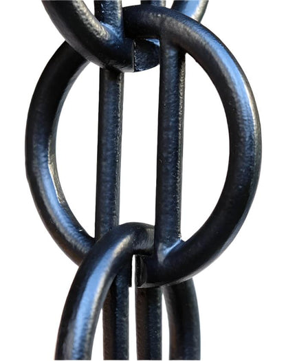 Detailed view of black geometric rain chain with vertical bars.