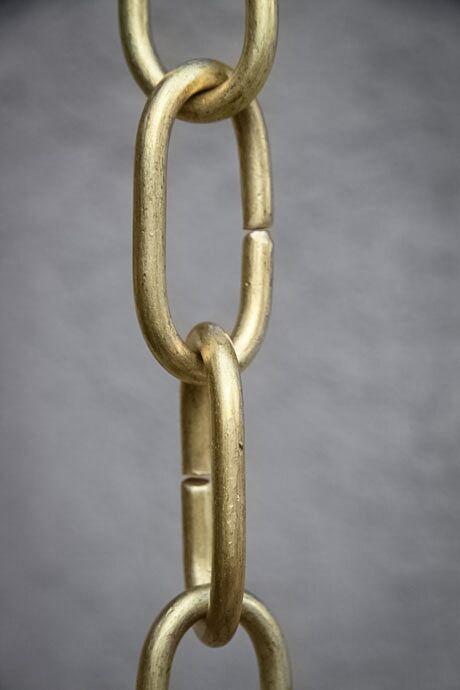 Detailed view of long brass link rain chain showcasing its craftsmanship.