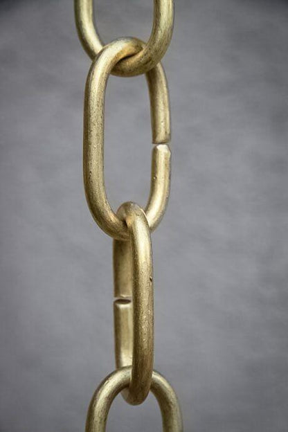 Detailed view of long brass link rain chain showcasing its craftsmanship.