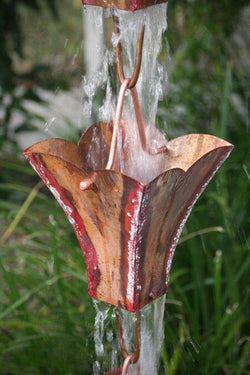 Large petal top cup rain chain in premium copper, showing decorative downspout and garden water feature design