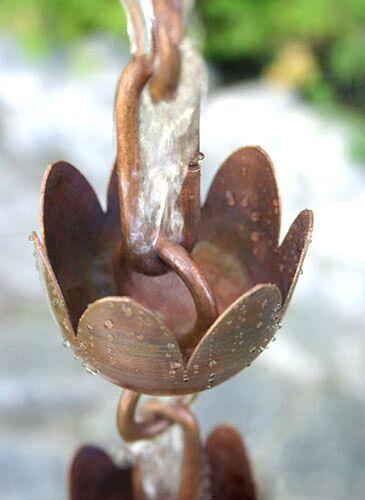 Tulip copper rain chain with water flowing through, showcasing its weather-resistant design.