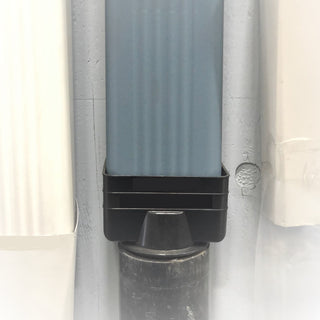 Black vinyl downspout reducer installed on a gutter system for smooth water flow.